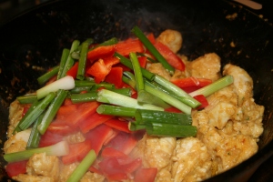 In a cast iron skillet, brown the chicken pieces. Add the vegetables.