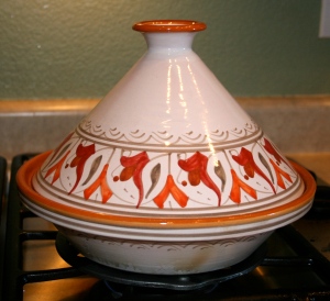 Place the tagine coned-lid on top of the base and simmer on low heat for 1 to 1 1/2 hours.
