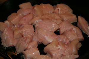 Add chicken to hot cast iron skillet.