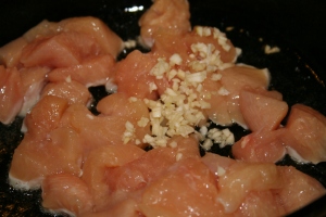 Add chicken and garlic, saute together until chicken is browned.