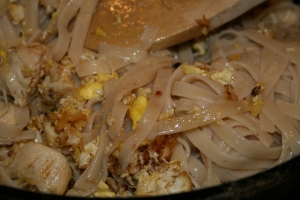 Add the cooked rice noodles.