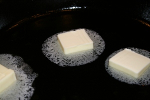 Melt 4 Tbsps. of butter in large skillet.